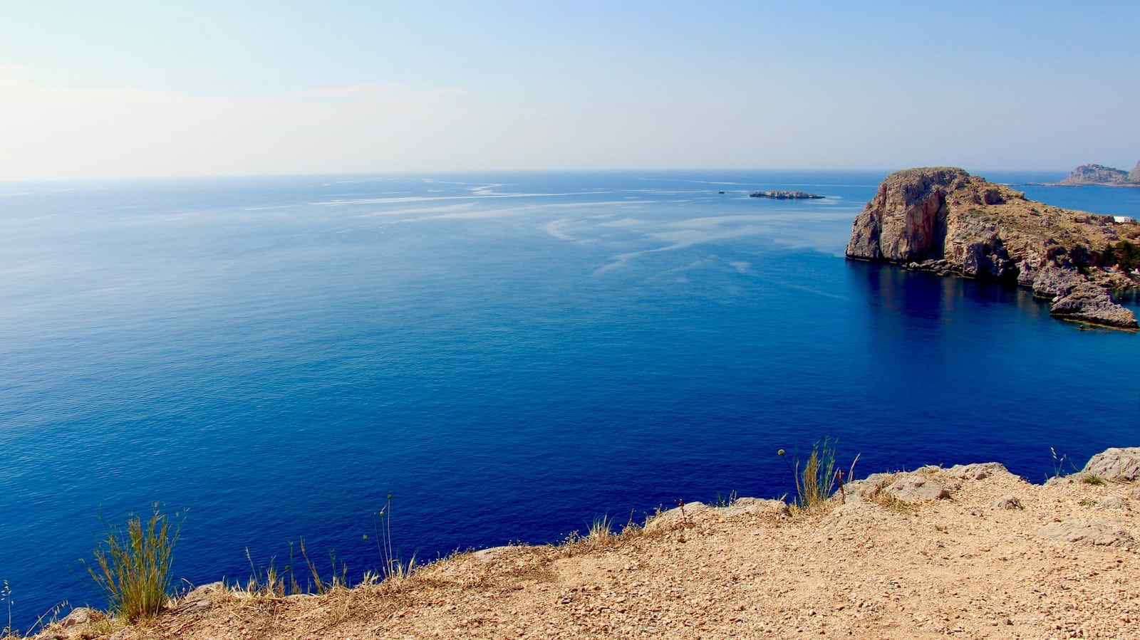 Deep blue Aegean water and rocky headlands at Lindos on Rhodes, Greece